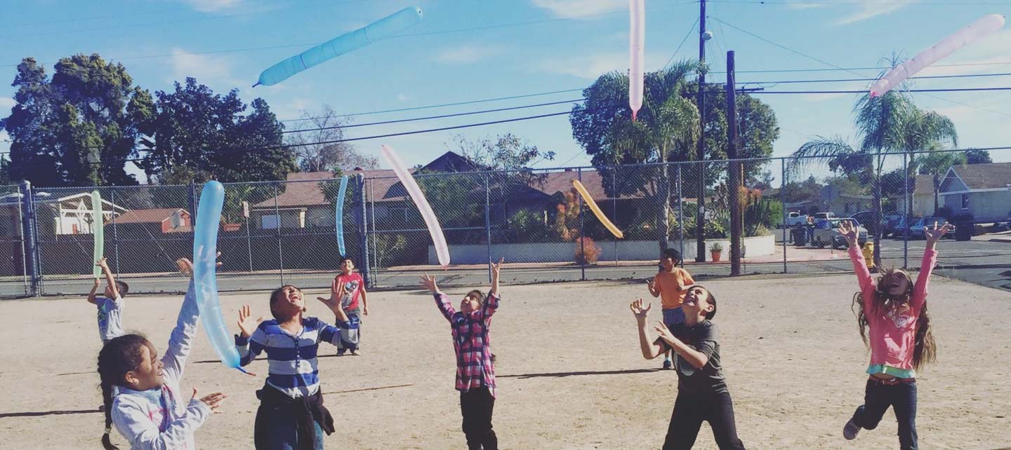 Kids playing with balloons in school yard