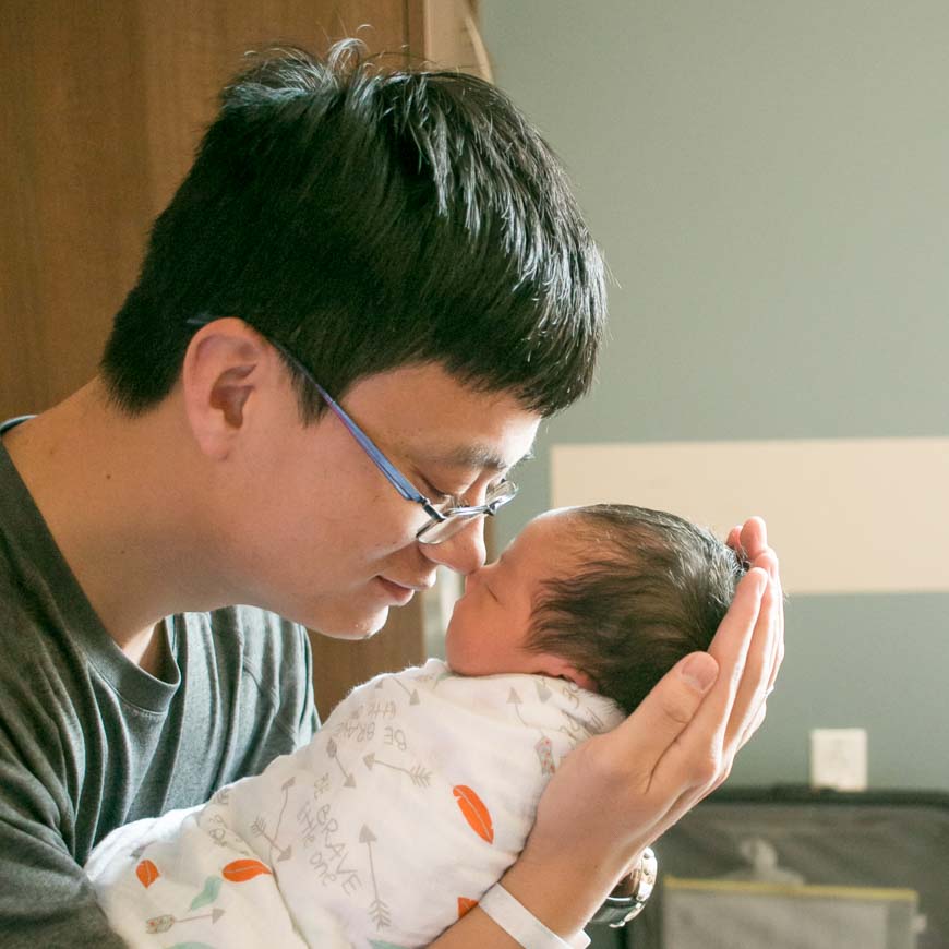 Emotional photo of Yingjun Zhao, research assistant professor at SBP, with baby son 