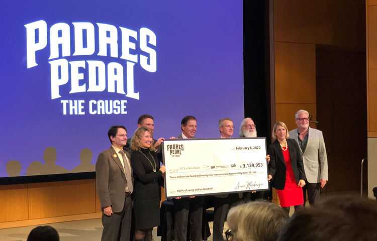 Garth Powis (fourth from left) who heads our National Cancer Institute (NCI)-designated Cancer Center—one of only seven in the nation—joined the beneficiaries onstage for a check presentation ceremony.