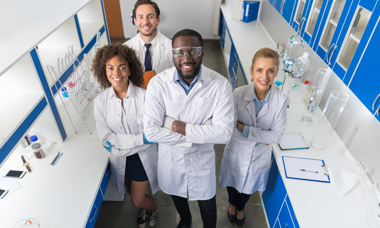 A group of young researchers standing in their lab