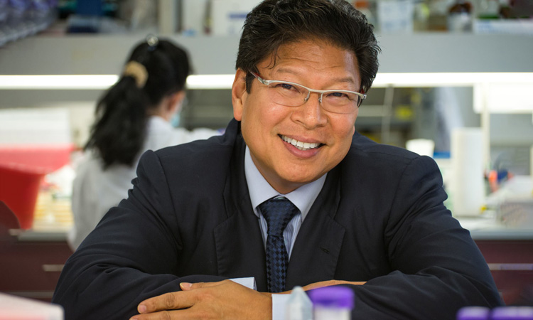 Sanford Burnham Prebys professor Jerold Chun, MD PhD, with his lab in the background