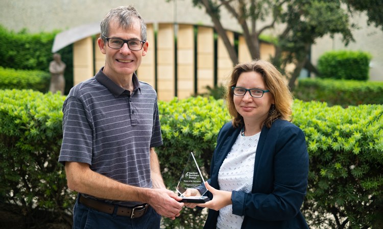 Peter Adams receives the Mentor of the Year Award from Marie Berenguer