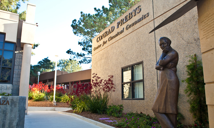 Conrad Prebys Center for Chemical Genomics with a bronze statue of a scientist in front