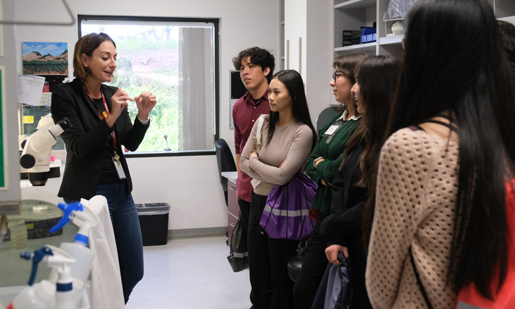 Caroline Kumsta speaking to STEM Shadow Day students in her lab