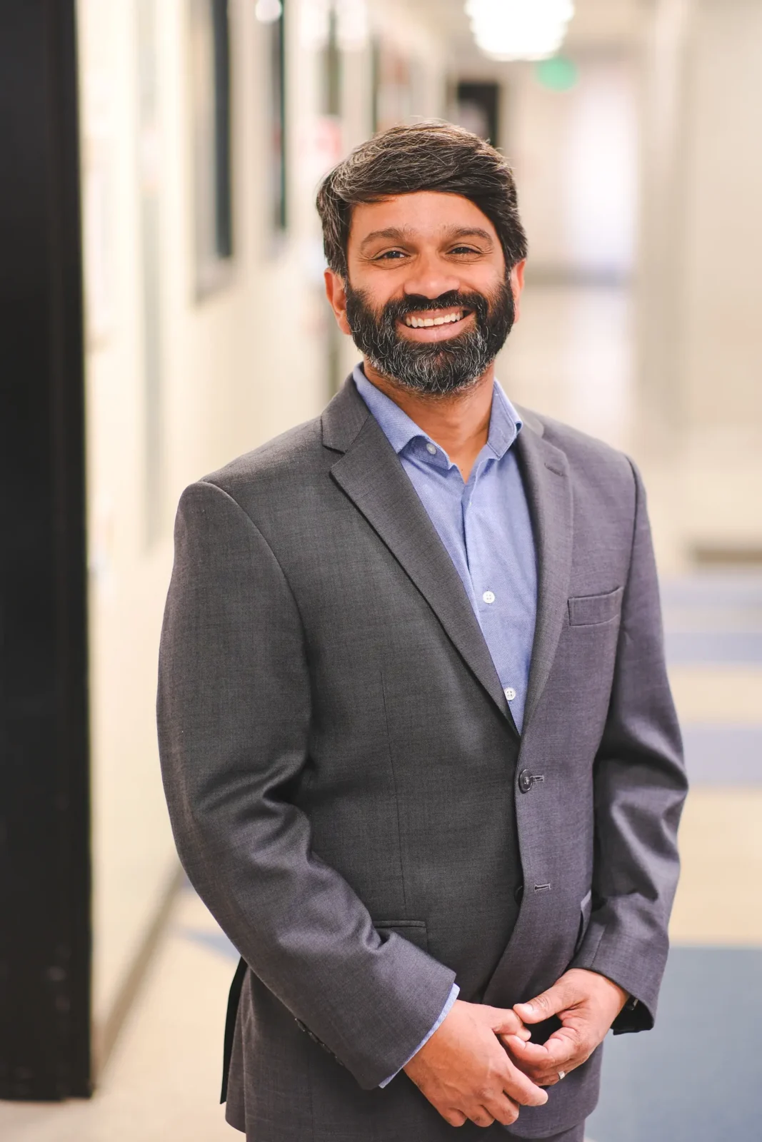Sanjeev Ranade, PhD, profile photo in lab hallway
