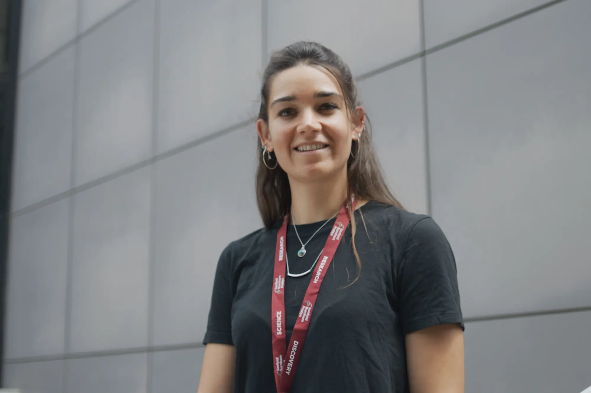 Young woman standing outside smiling