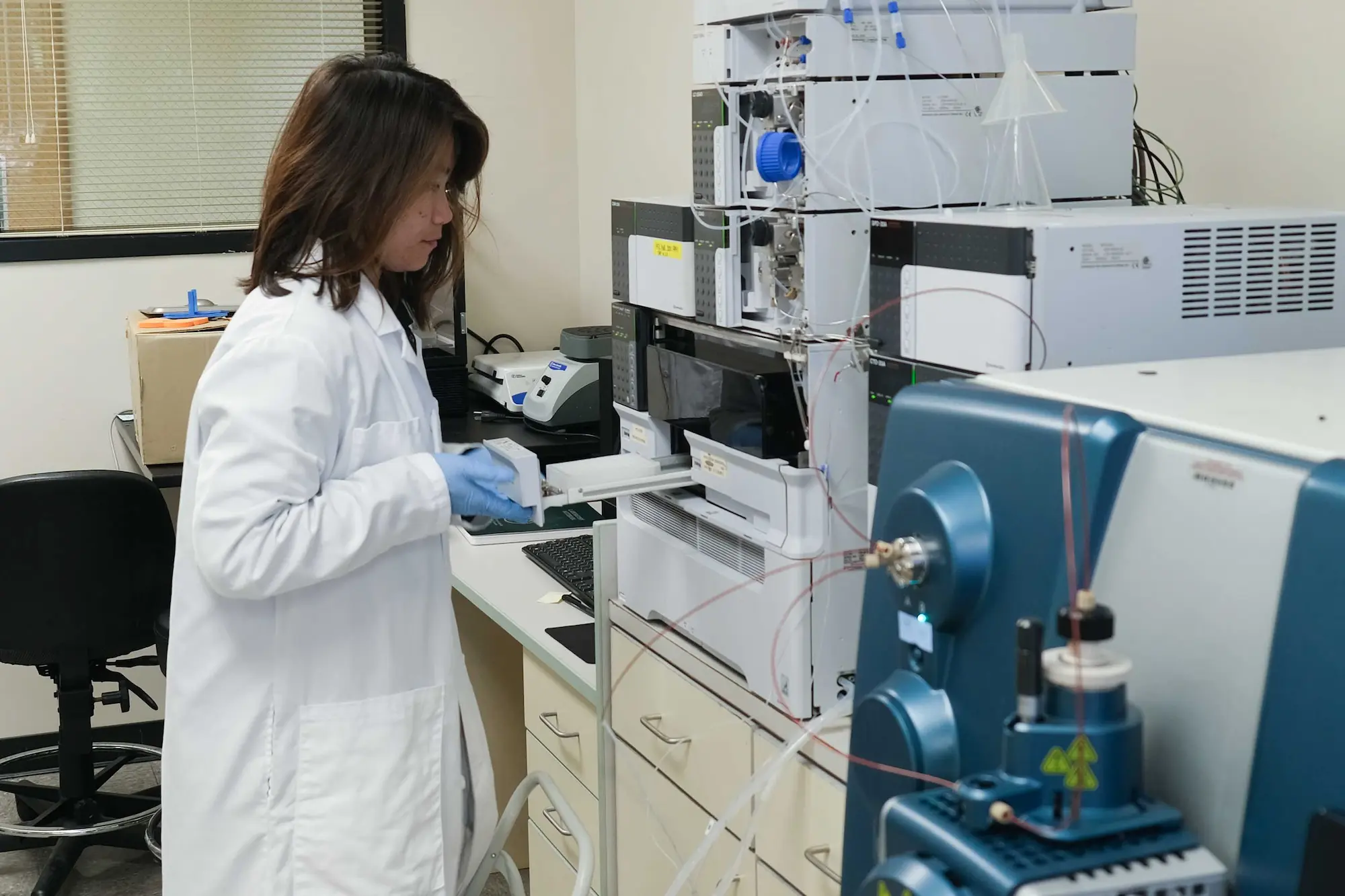 A scientist works with lab equipment