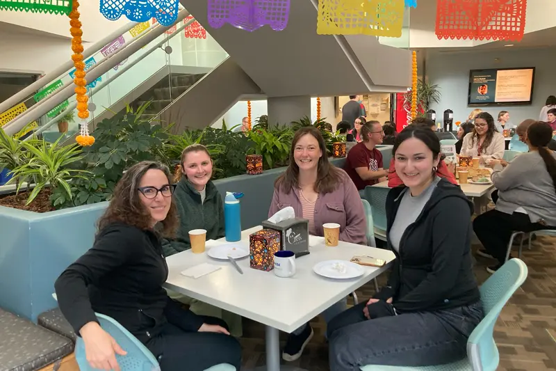 group of employees eating lunch at Institute Dia de los Muetos celebration