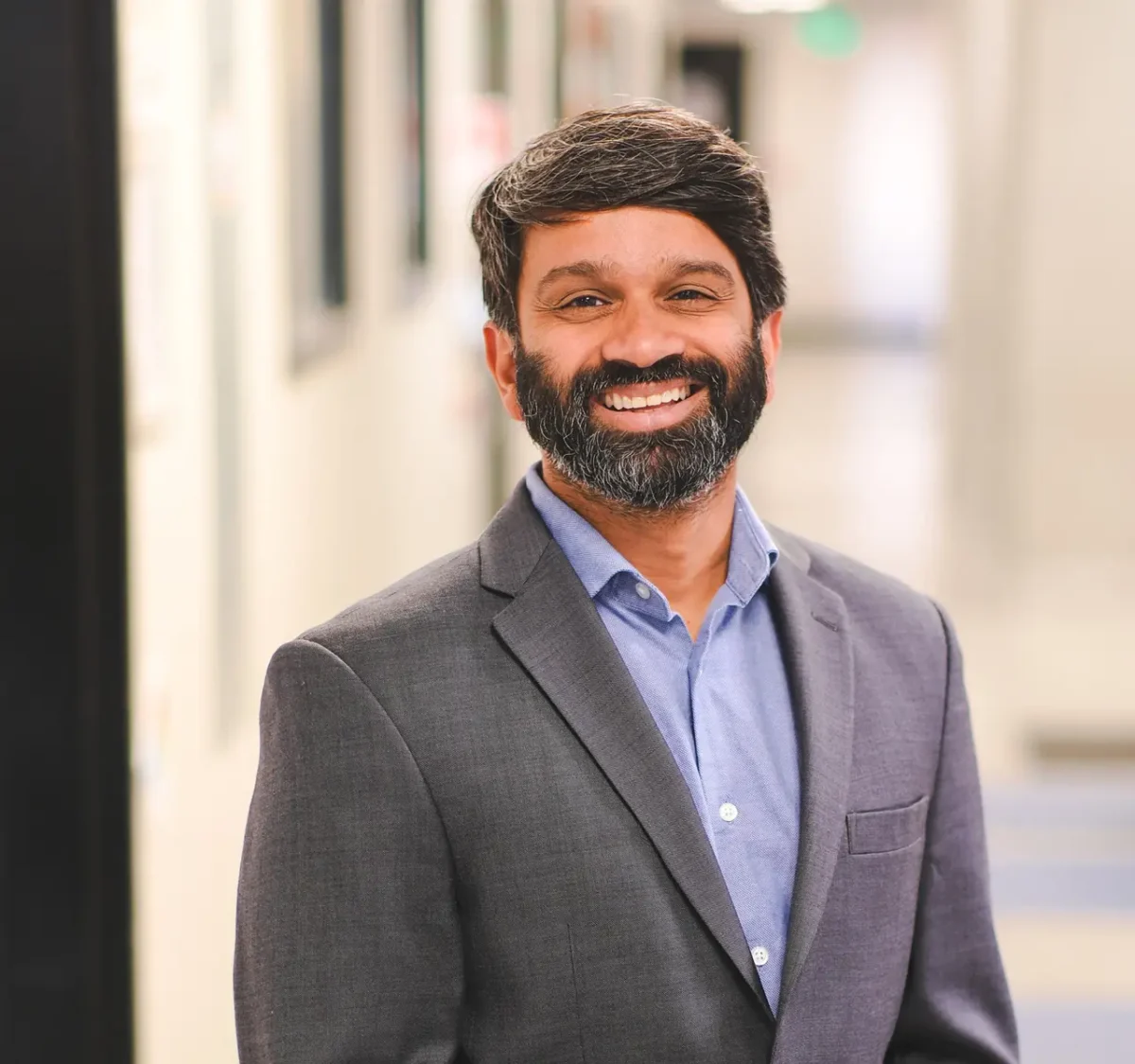 Sanjeev Ranade, PhD, profile photo in lab hallway
